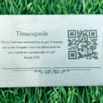 medium steel qr code plaque sitting on grass