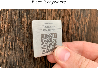 place-anywhere hand placing timecapsule qr code plaque on a wooden fence